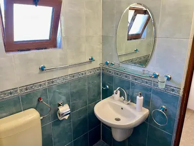 a bathroom with a sink and a mirror at Къща за Гости Чайка in Byala