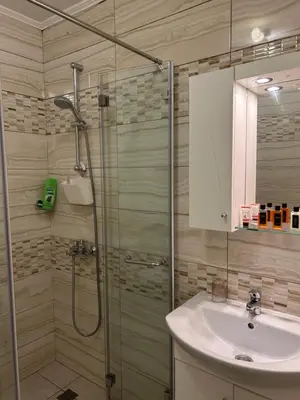 a bathroom with a shower and a sink at GREAT Apartament in Burgas City