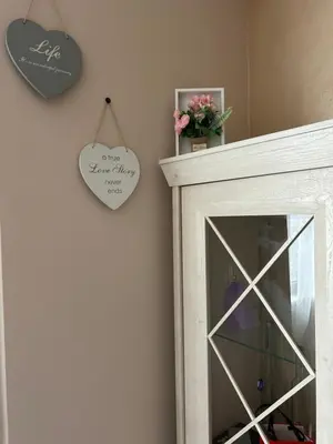 a mirror in a room with a heart on the wall at GREAT Apartament in Burgas City