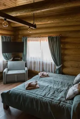 a bedroom with two beds in a wooden room at Къщи за гости Стара Голица in Golitsa