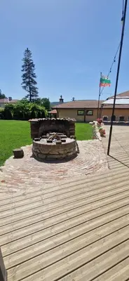 a wooden deck with a fire pit in a yard at Къщи за гости Стара Голица in Golitsa