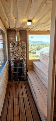 an inside view of a cabin with a fireplace at Къщи за гости Стара Голица in Golitsa