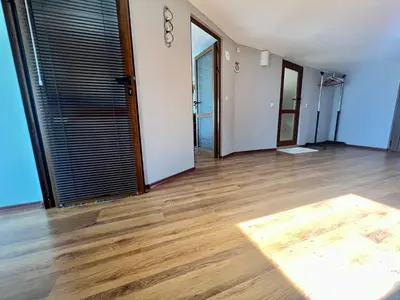 an empty living room with wooden floors and a door at Vista Sul Mare V in Kraymorie