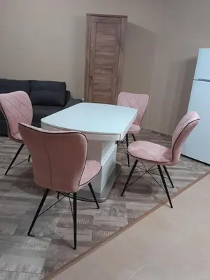 a white table and pink chairs in a living room at студио Орхидея Сарафово лукс с изглед към морето in Burgas City