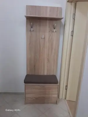a wooden cabinet with a bench in a room at студио Орхидея Сарафово лукс с изглед към морето in Burgas City