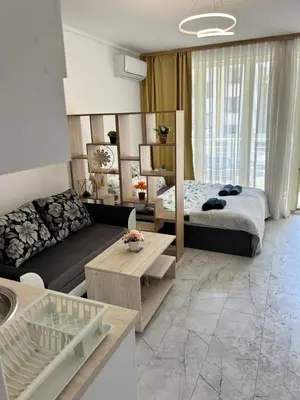 a living room with a bed and a couch at Studio Dream Мечта in Sunny Beach