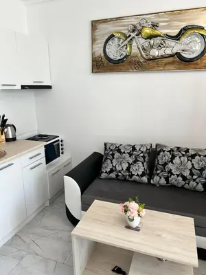 a living room with a couch and a table at Studio Dream Мечта in Sunny Beach