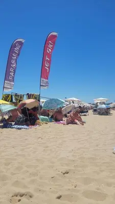 a group of people laying on the beach with umbrellas at Studio Dream Мечта in Sunny Beach