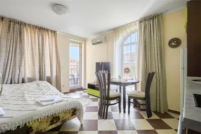 a bedroom with a bed and a table and chairs at Hacienda Beach Studio with Pool by Flat Mаnаger in Sozopol