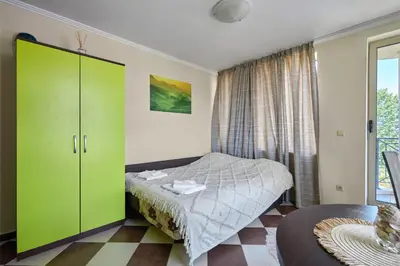 a bedroom with a green cabinet and a bed at Hacienda Beach Studio with Pool by Flat Mаnаger in Sozopol