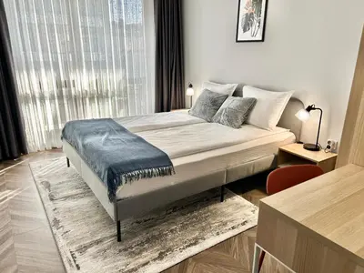 a bedroom with a bed and a large window at 