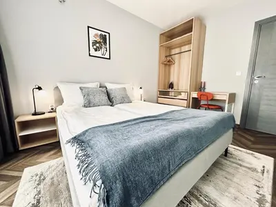 a bedroom with a large bed with a blue blanket at 