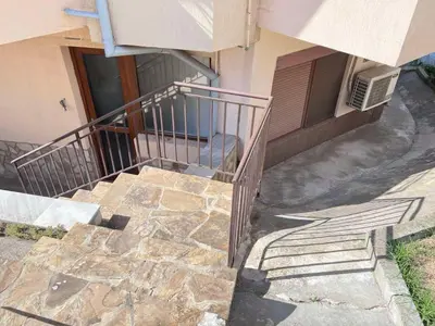 a stairway leading up to a building with a door at Apartment Divna in Sozopol