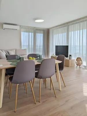 a living room with a dining room table and chairs at Foros Apartment in Kraymorie