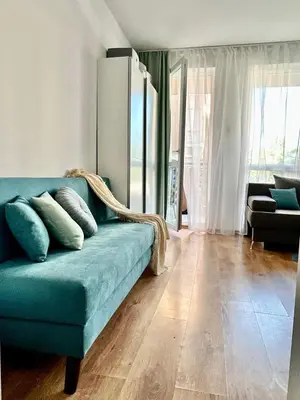 a blue couch sitting in a living room at Mint Casa Rossa in Sunny Beach