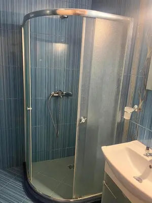 a shower with a glass door in a bathroom at На гости в Созопол in Sozopol