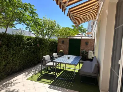 a table and chairs on the patio of a house at Doris Beach apartment D06 in Burgas City