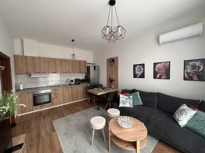a living room with a couch and a table at Doris Beach apartment D06 in Burgas City