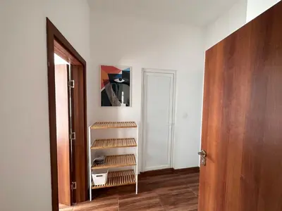 an empty room with a wooden door and a shelf at Doris Beach apartment D06 in Burgas City