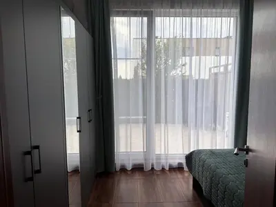 a bedroom with a bed and a large window at Doris Beach apartment D06 in Burgas City