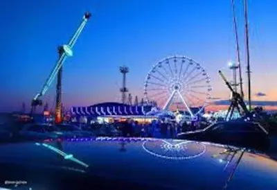 a ferris wheel and a ferris wheel at a carnival at Varna Central Sea Apartment in Varna City