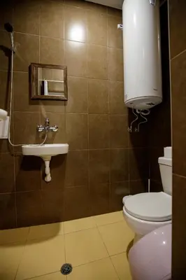 a bathroom with a toilet and a sink at Varna Central Sea Apartment in Varna City