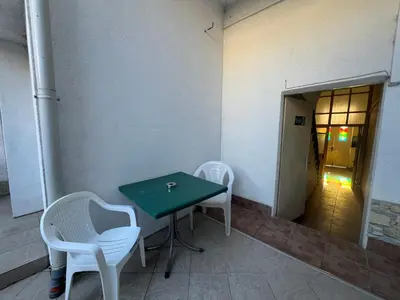 a green table and two white chairs in a room at Varna Central Sea Studio in Varna City