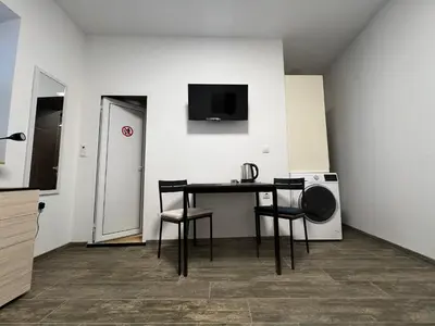 a room with a table with chairs and a microwave at Varna Central Sea Studio in Varna City