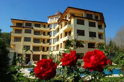 a large building with red flowers in front of it at Nice 2 Bedrooms With Ocean View In Byala in Byala