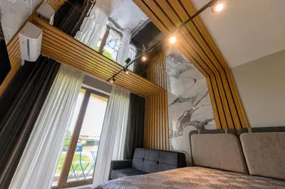a bedroom with a bed and a large window at Azur Properties ap19 in Shkorpilovtsi