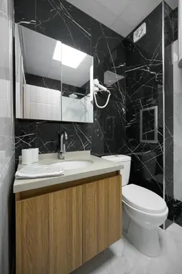 a bathroom with a toilet and a sink and a mirror at Azur Properties ap19 in Shkorpilovtsi