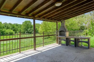 an outdoor patio with a bench and a grill at Azur Properties ap19 in Shkorpilovtsi