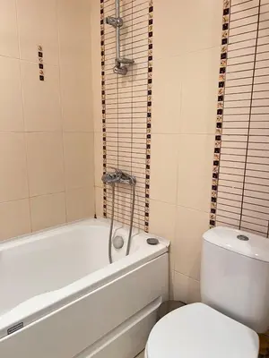 a bathroom with a white tub and a toilet at Green Life Sozopol in Sozopol