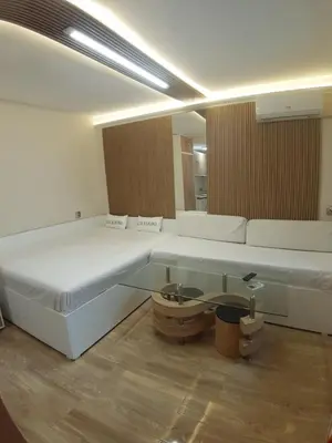 a room with two beds and a glass table at Apartment TINA in Varna City