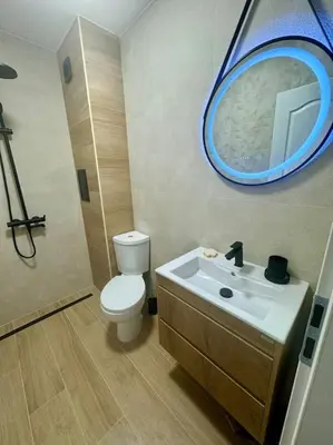 a bathroom with a toilet and a sink with a mirror at South Beach Apartment Primorsko in Primorsko