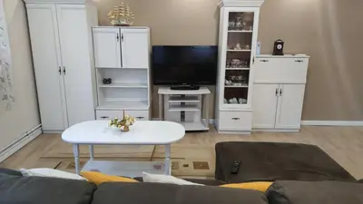 a living room with a couch and a table at Aпартамент Жужа in Nesebar