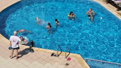 a group of people in a swimming pool at Wspaniały apartament w kompleksie Galateya in Sveti Vlas
