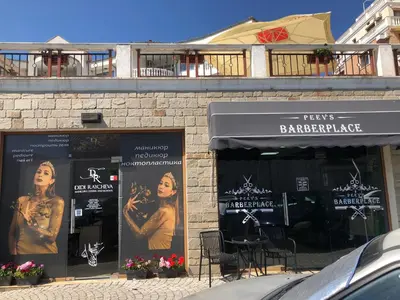 a store with posters in the windows of a building at 2 bedroom apartment Sveti Vlas with 2 balconies and sea views in Sveti Vlas