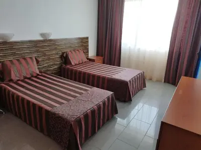 a hotel room with two beds and a window at California complex in Sunny Beach