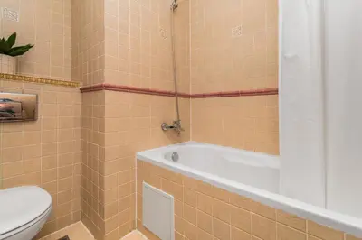 a bathroom with a bath tub and a toilet at Royal Bay Apartaments - Sveti Vlas in Sveti Vlas