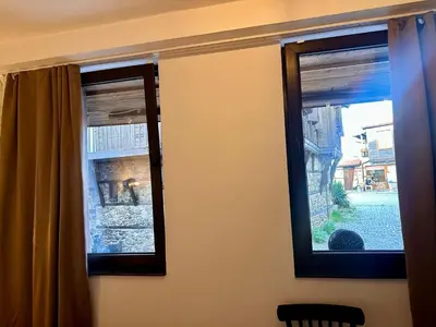 two windows in a room with a curtain at Arthotel Oscar I Sozopol in Sozopol