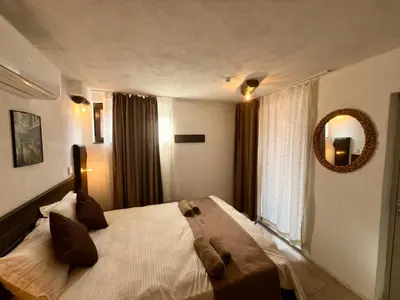 a bedroom with a large bed with a mirror on the wall at Arthotel Oscar I Sozopol in Sozopol