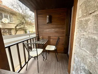 a porch with two chairs and a table on a balcony at Arthotel Oscar I Sozopol in Sozopol