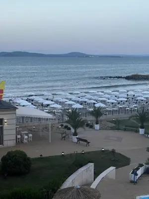 a view of a beach with umbrellas and the ocean at Private room Festa Pomorie in Pomorie