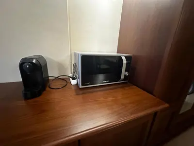 a small television sitting on top of a wooden table at Private room Festa Pomorie in Pomorie