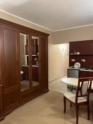 a living room with a table and a kitchen at Private room Festa Pomorie in Pomorie