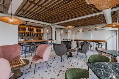 a room with chairs and tables and a bar at Casa Deniso - The Home of Chill in Byala