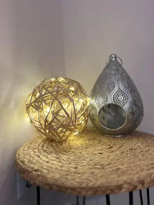 two lights on a table next to a vase at Apartment Blue Summer II in Varna City