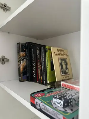 a row of books sitting on a shelf at Manolovi Guest House in Obzor