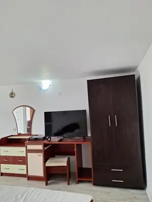 an office with a desk with a computer and a cabinet at Manolovi Guest House in Obzor